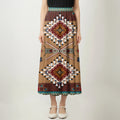 Front view of an asymmetrical maxi skirt with Native American Navajo Aztec geometric patterns and a teal waist detail.
