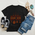 Black t-shirt displaying brown teepee and feather totem graphic with quote “American History Begins with Native History.