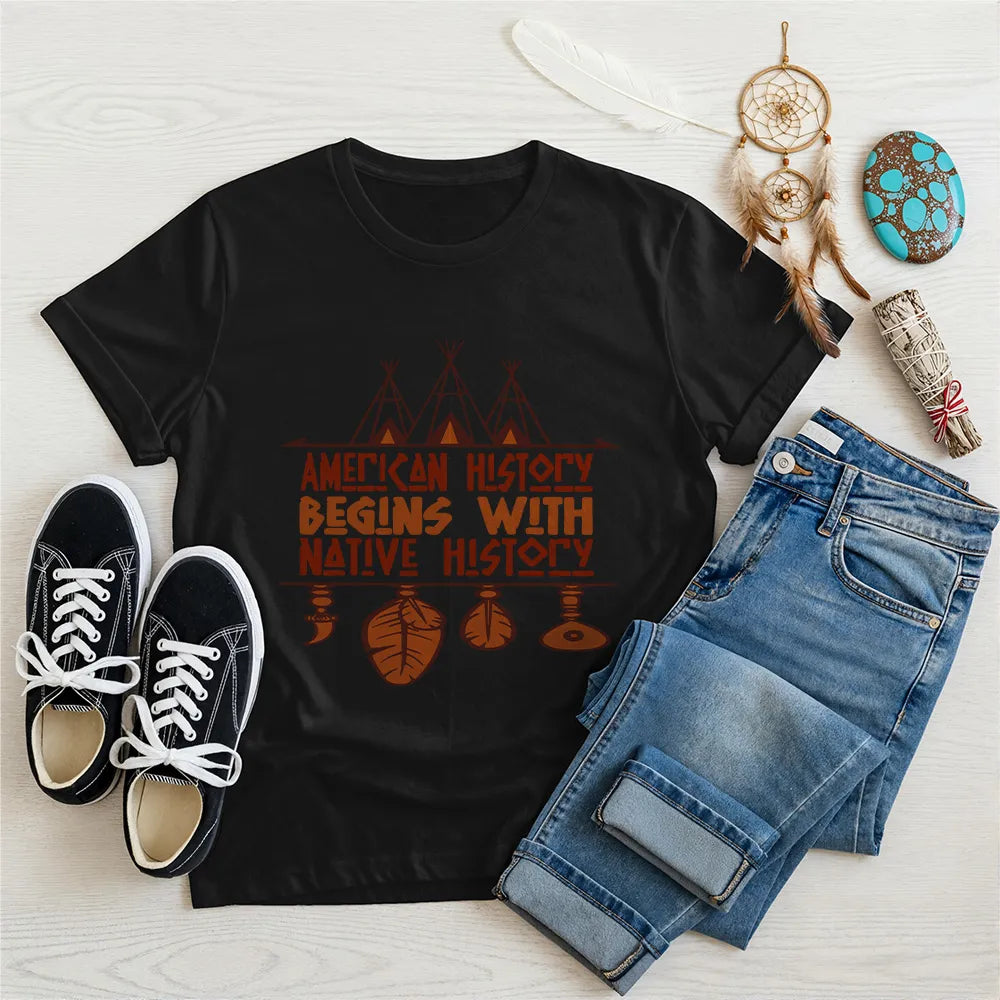Black t-shirt displaying brown teepee and feather totem graphic with quote “American History Begins with Native History.