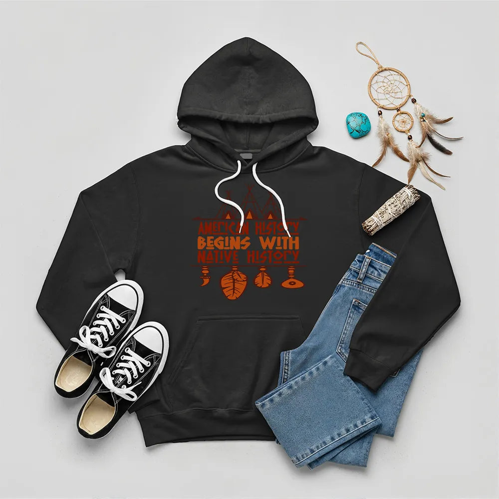 Black hoodie featuring brown teepee and feather totem graphic with quote “American History Begins with Native History