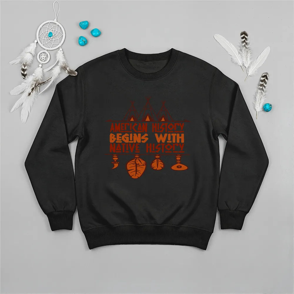 Black crewneck sweatshirt featuring a sacred teepee and feather totem design with the quote “American History Begins with Native History