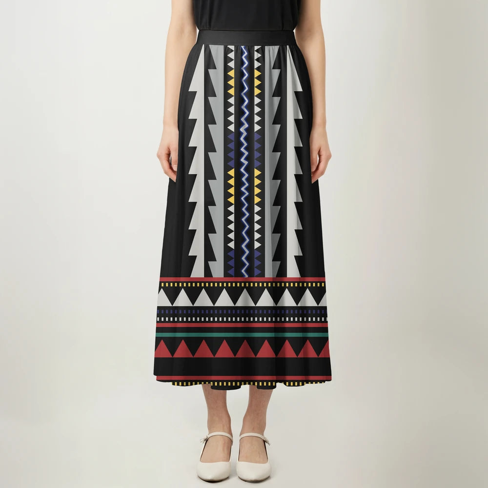 Woman posing in a black and white geometric tribal dress and skirt, perfect for summer outings or beachside vacations.