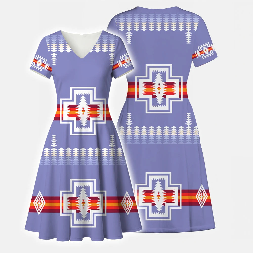 Blue V-neck dress with a prominent eagle/thunderbird motif and geometric patterns