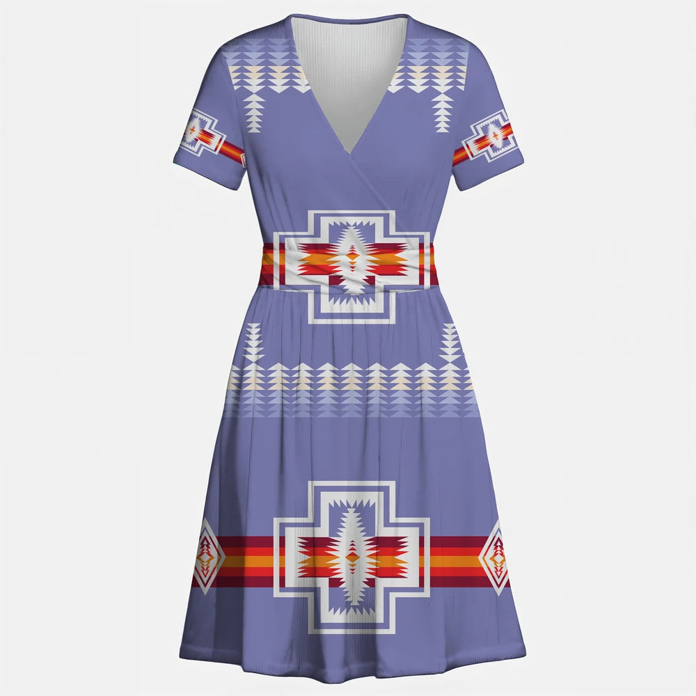 Blue V-neck dress with a prominent eagle/thunderbird motif and geometric patterns