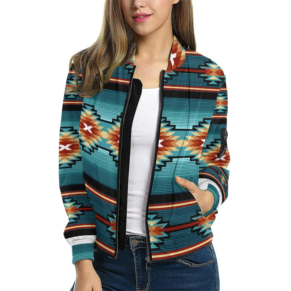 A female model showcases the Canyon Ridge Tribal Bomber Jacket, styled over a white top and jeans. The geometric design pops with cultural texture and modern flair, highlighting the comfortable fit and smooth zipper.