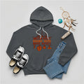 Charcoal gray hoodie featuring brown teepee and feather totem graphic with quote “American History Begins with Native History.