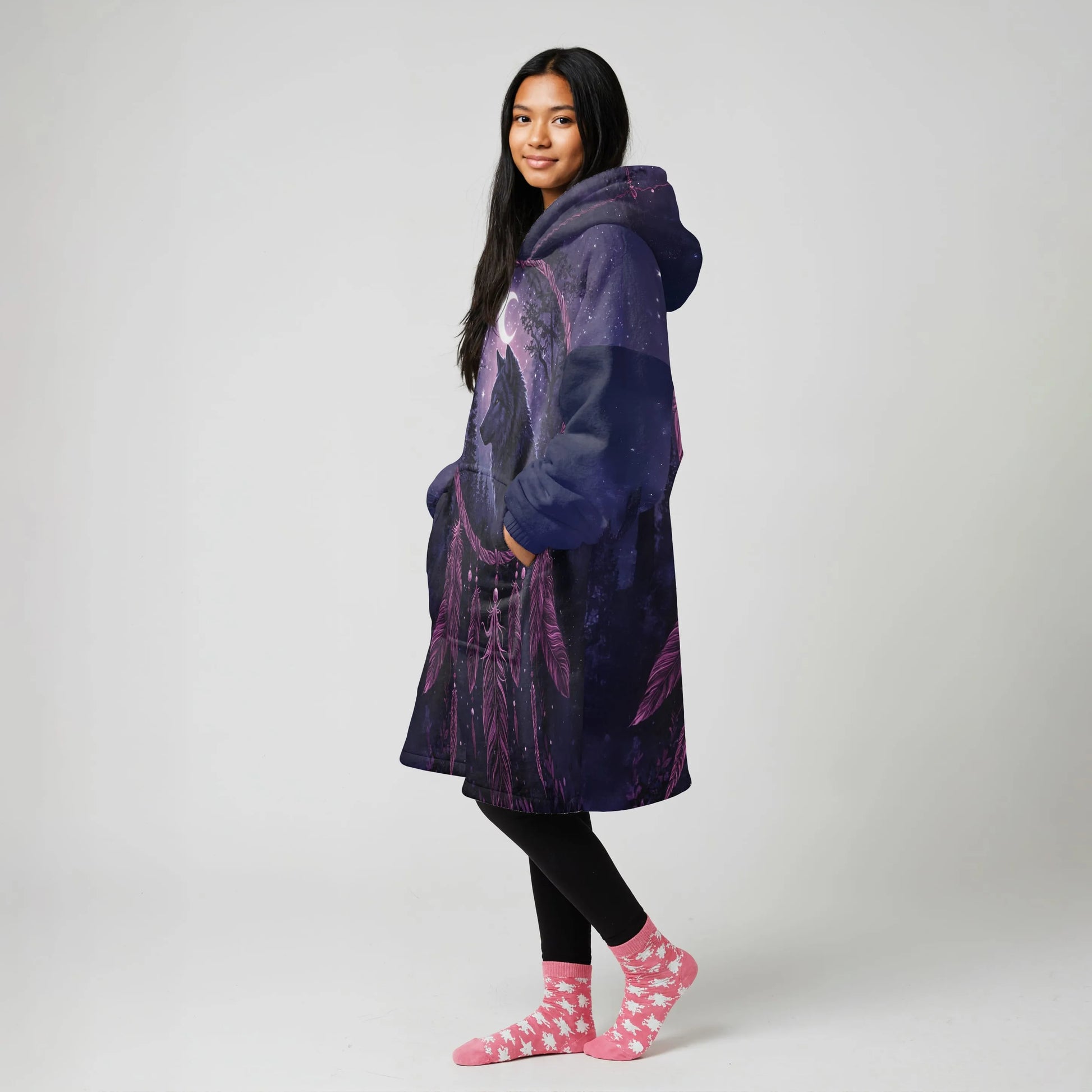 Model indoors wearing a purple wearable blanket jacket with rust and cream tribal stripes and a warm Sherpa lining, hands in pockets
