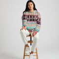Woman standing in a cozy living room wearing a cozy Southwestern Native American Inspired Fleece Jacket Indoors