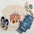 Cream-colored t-shirt displaying brown teepee and feather totem graphic with quote “American History Begins with Native History