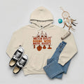 Cream hoodie featuring brown teepee and feather totem graphic with quote “American History Begins with Native History.