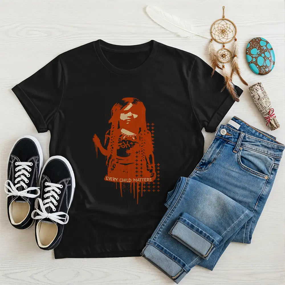 Black Native America tee with symbolic Indigenous girl graphic and powerful message, styled with denim and sneakers.