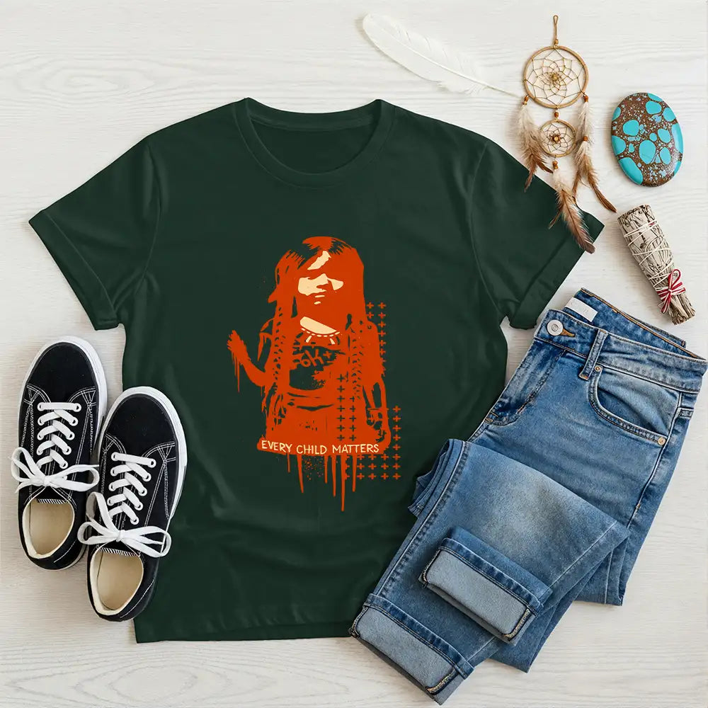 Forest green t-shirt featuring Indigenous child image and "Every Child Matters" text, paired with casual jeans and shoes.