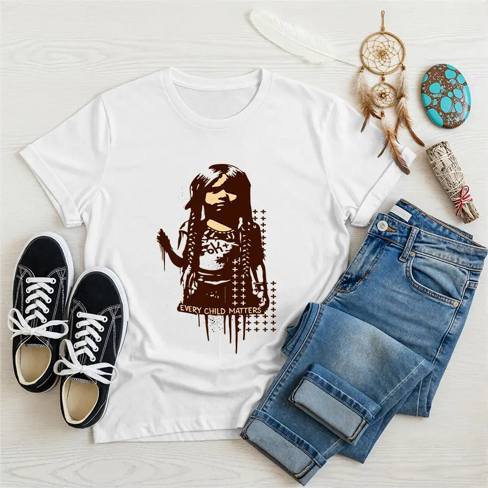 Orange unisex t-shirt with bold Indigenous child print and "Every Child Matters" text, styled with denim pants and casual shoes.