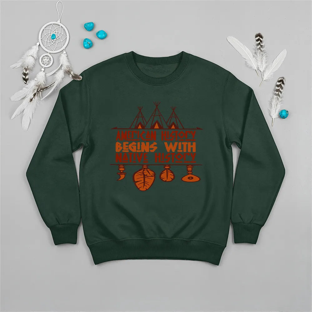 Forest green crewneck sweatshirt featuring a sacred teepee and feather totem design with the quote “American History Begins with Native History.”