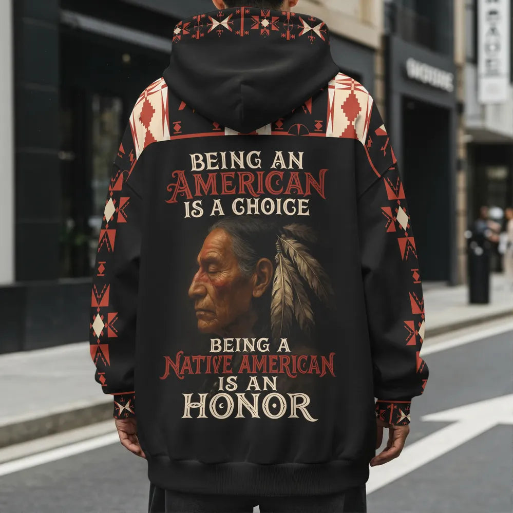 Model photographed from the back wearing a black and deep-red fleece hoodie with the bold slogan “NO ONE IS ILLEGAL ON STOLEN LAND” printed down the center