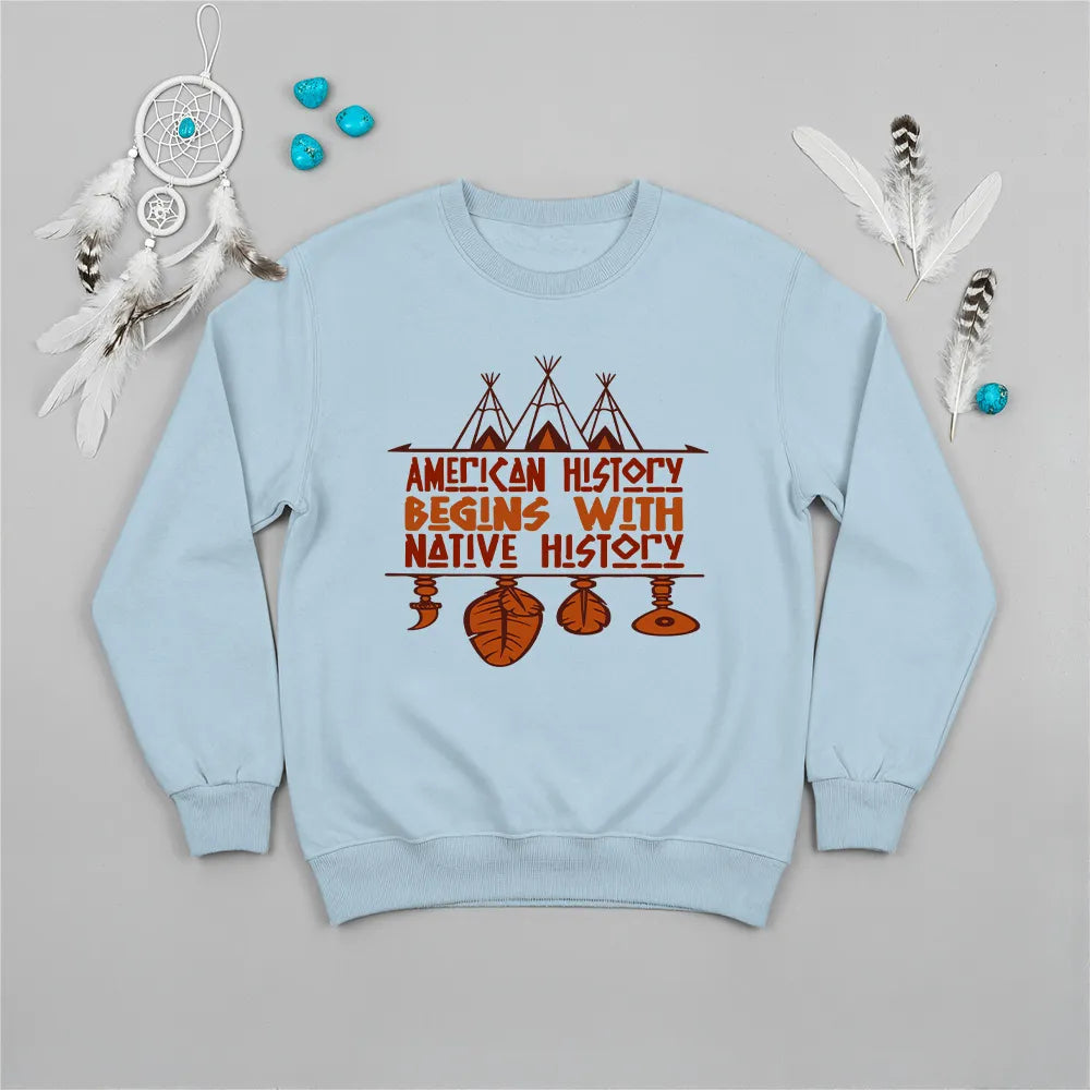 Light blue crewneck sweatshirt featuring a sacred teepee and feather totem design with the quote “American History Begins with Native History.