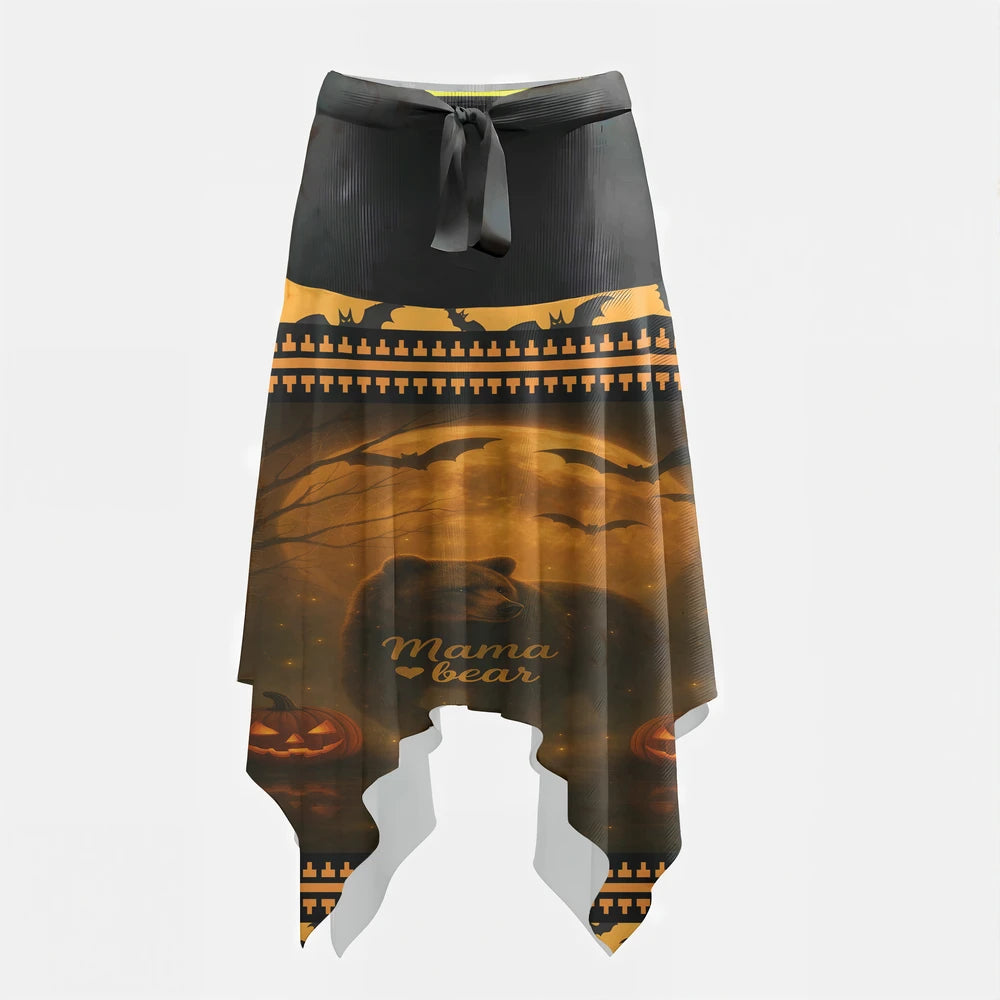 Full-length image of a woman wearing a black and orange midi skirt. The top portion of the skirt features a "Mama Bear" graphic with a bear silhouette, moon, bats, and pumpkins against an orange sky, while the lower portion has an all-over black bat pattern on an orange background.