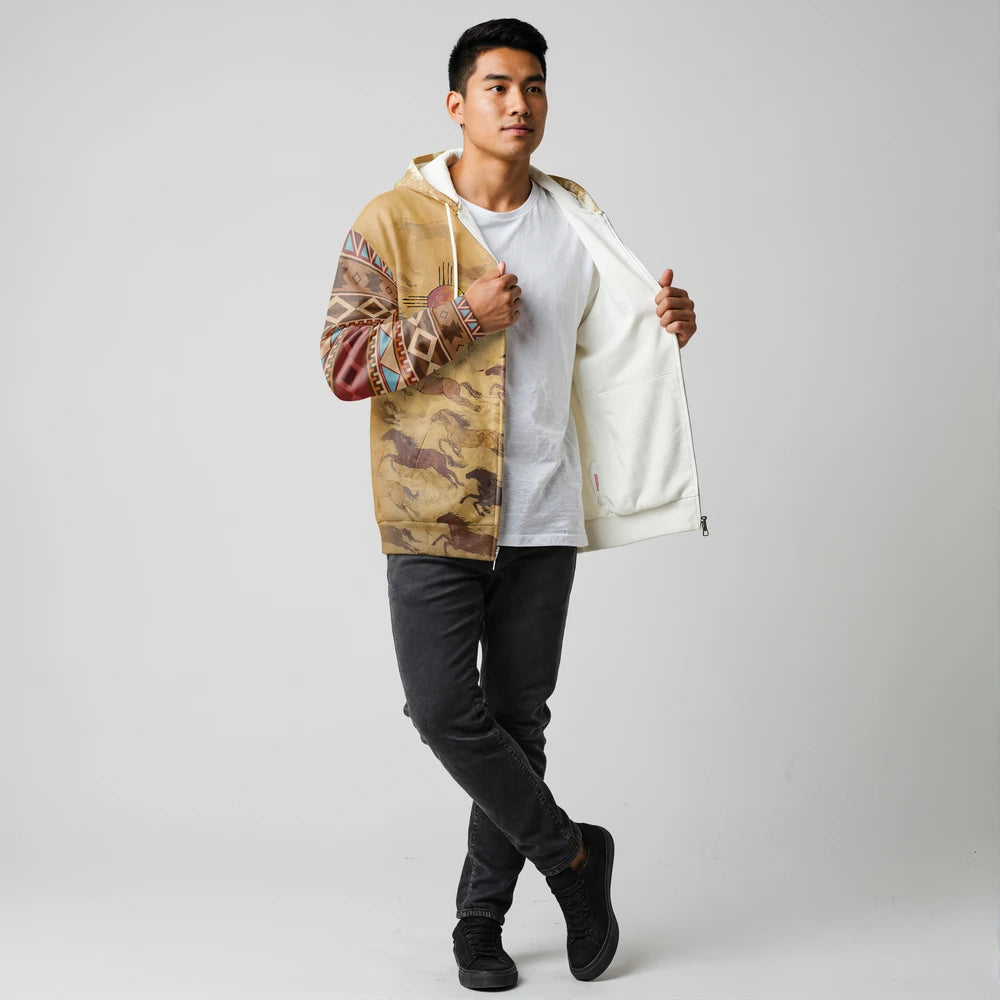 Male model in a brown Native-American–inspired tribal print jacket, shown open to reveal the light fleece lining, standing against a seamless grey background
