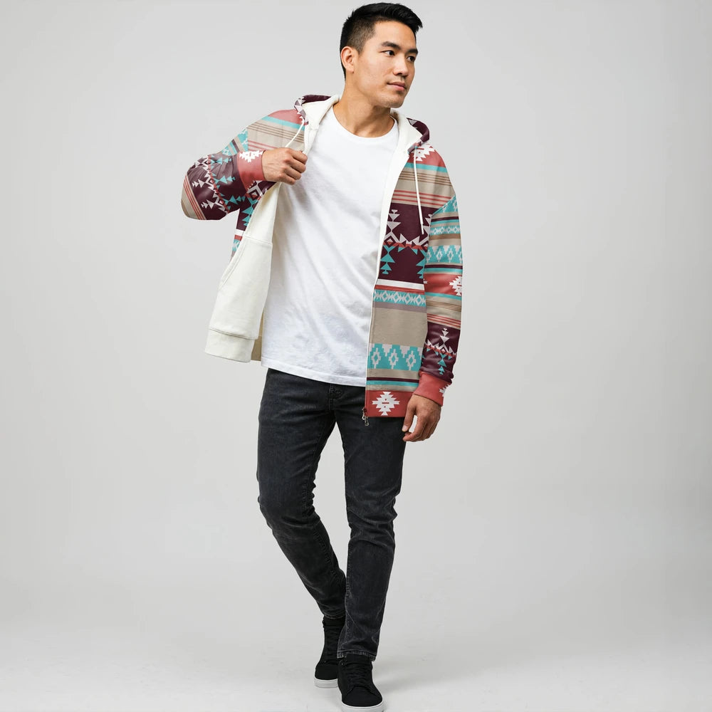 Male model wearing a multicolor Native-American–inspired zip-up jacket over a white tee, demonstrating the inside fleece lining against a neutral studio background