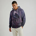 Front-facing male model wearing a purple Dreamcatcher–patterned Native-inspired blanket hoodie with relaxed fit and kangaroo pocket