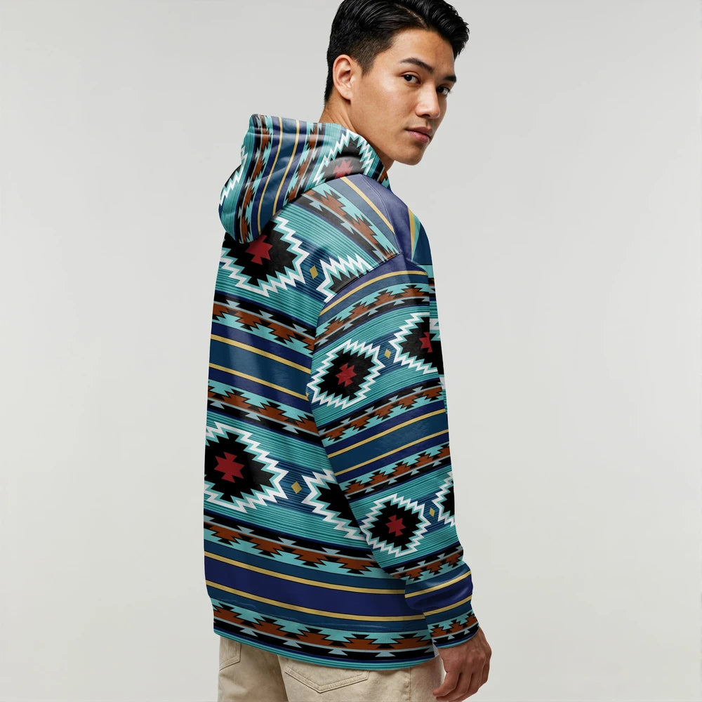 Side view of a male model in a teal and black tribal wearable blanket hoodie, showing bold geometric print and relaxed fit