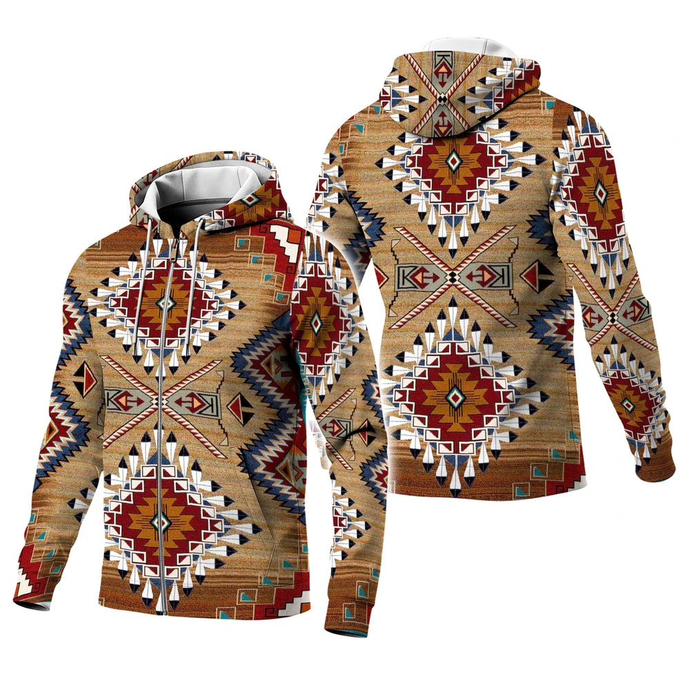 Female model in a brown diamond-patterned Native-American–inspired hoodie, hand running through hair, standing against a light studio wall