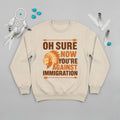 Native America graphic beige sweatshirt with traditional chief headgear and 'Oh Sure Now You’re Against Immigration' text