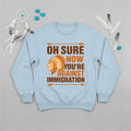 Native America graphic blue sweatshirt with traditional chief headgear and 'Oh Sure Now You’re Against Immigration' text.