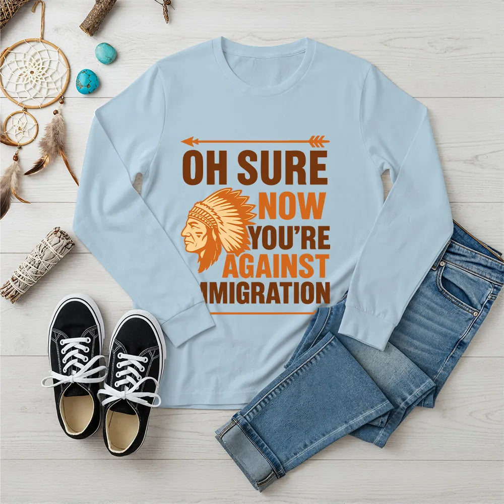 "Native American long sleeve tee with orange chief headdress and immigration statement."