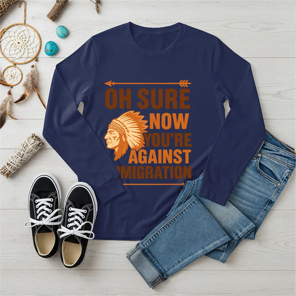 "Native American long sleeve tee with brown chief headdress and immigration statement."