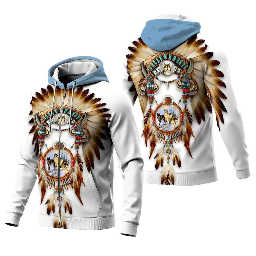 Front view of a male model in a white Native-American–inspired hoodie printed with a dreamcatcher medallion, hood up and hand adjusting the drawcord
