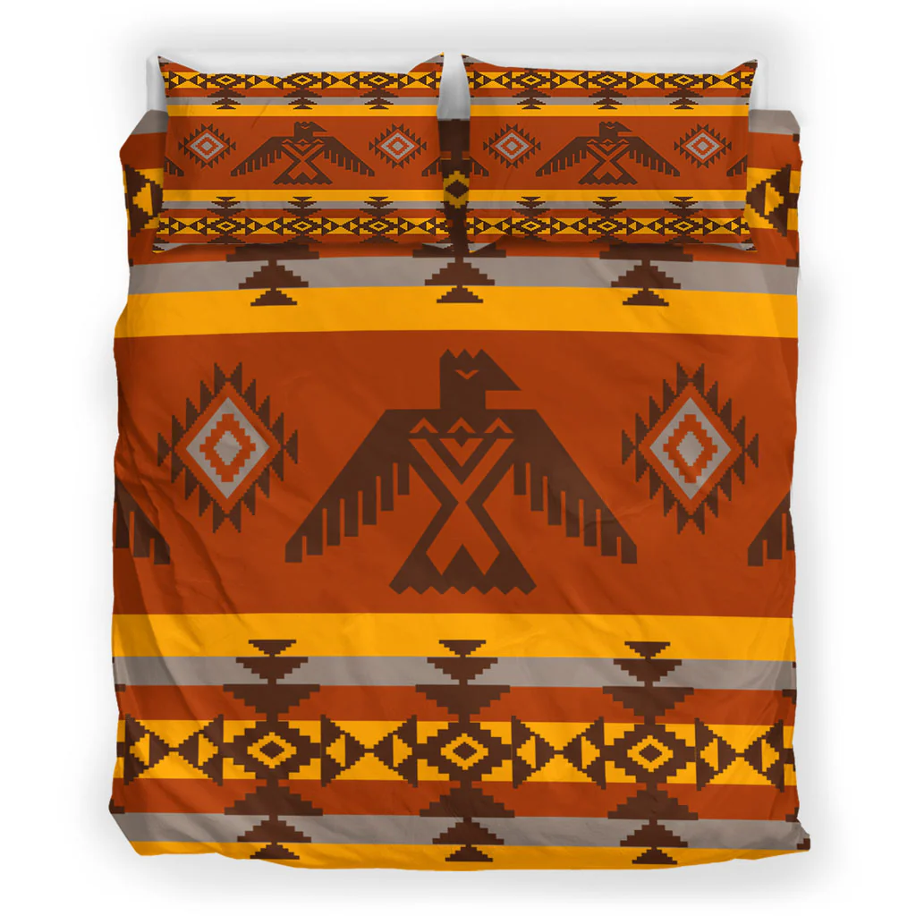 Top view of bedding set showcasing Native American tribal geometric patterns in vibrant earth tones on a bed with matching pillowcases.