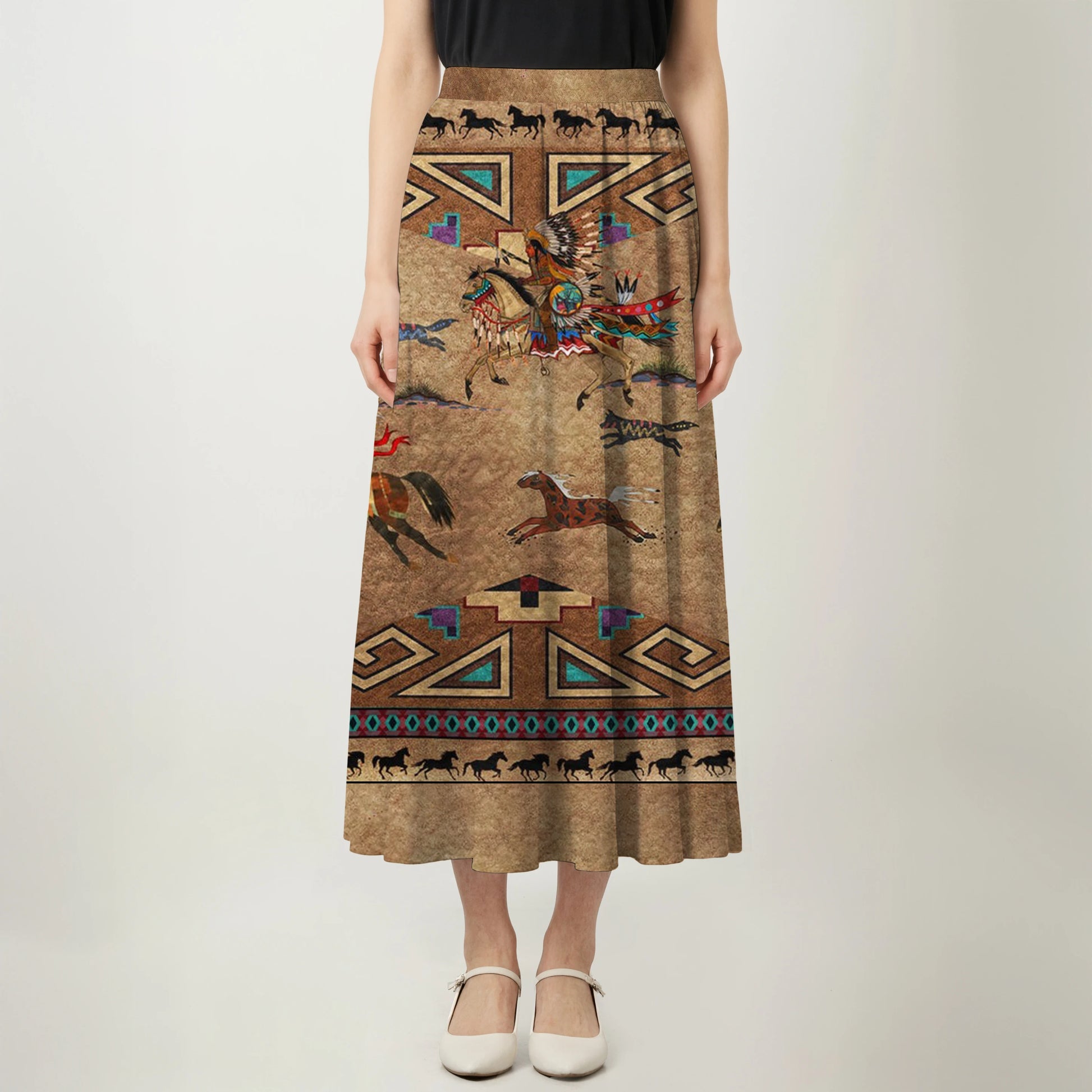 Front view of a woman wearing a black top and a midi A-line skirt, which features a tan-brown background with a Native American inspired print of warriors on horseback, running horses, and intricate geometric patterns.
