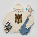 Beige hoodie with an owl and dreamcatcher design, embodying Native cultural symbols of peace and guidance.