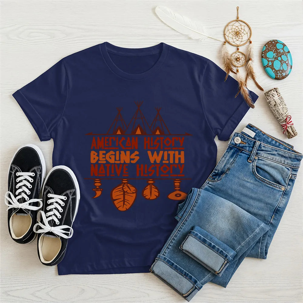 Light blue t-shirt displaying brown teepee and feather totem graphic with quote “American History Begins with Native History.