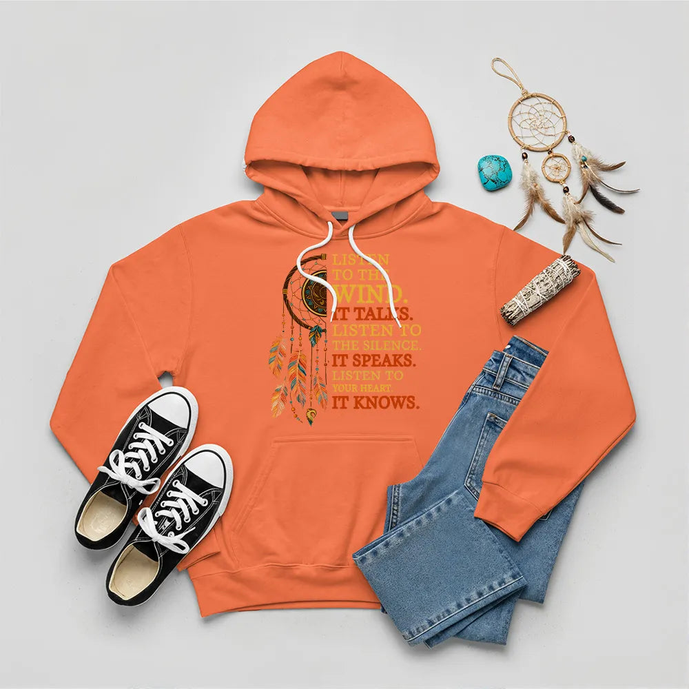 Orange hoodie with Indigenous‑style dreamcatcher and ‘It Speaks’ quote graphic