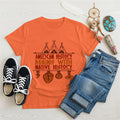 Orange t-shirt displaying brown teepee and feather totem graphic with quote “American History Begins with Native History.