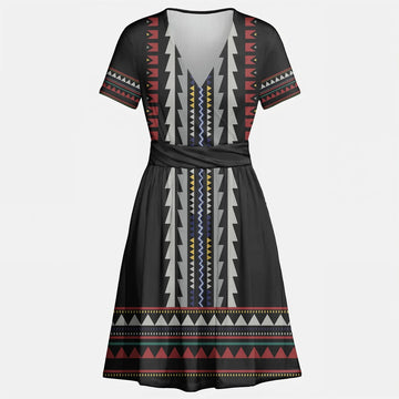 Model in a flowy black geometric dress and skirt set with tribal Southwest print, styled for a casual boho festival look.