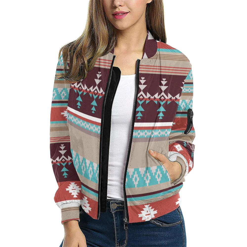  female model styled in the Southwestern Native American Inspired Bomber Jacket, highlighting the bold turquoise and rust-colored motifs layered horizontally across a neutral backdrop, paired with a white top and denim jeans.