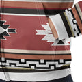 Detailed close-up of the kangaroo pocket area showing the terracotta and cream tribal motifs and geometric black-and-white trim against the fleece fabric.