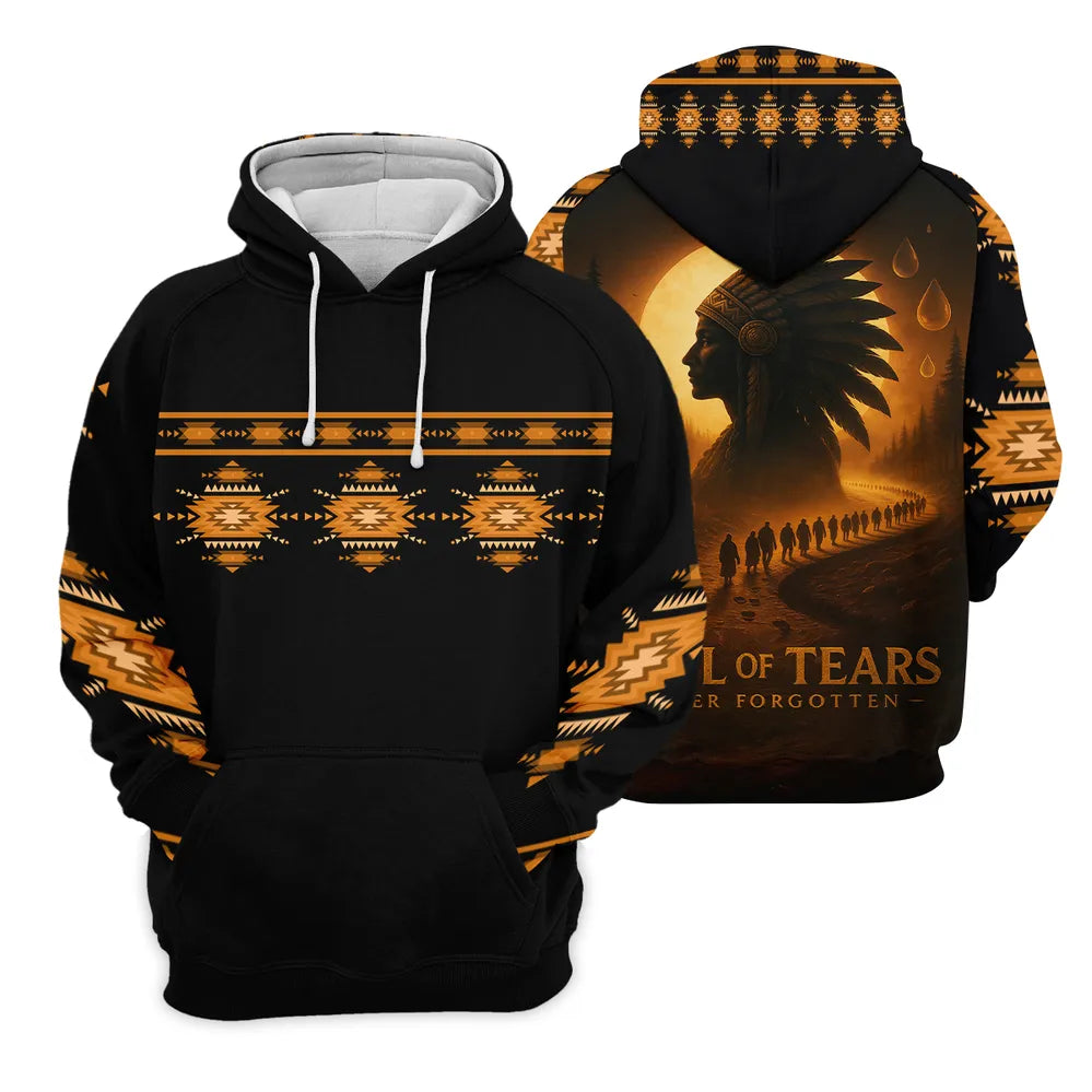 Black pullover hoodie with orange geometric pattern on sleeves and chest; hood interior white, back displays a golden‑toned silhouette of a Native American headdress and a column of walkers under a moon, captioned “Trail of Tears – Never Forgotten.”