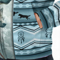 Close-up of blue tribal stripes with silhouetted wolves and dreamcatcher motifs on fabric texture