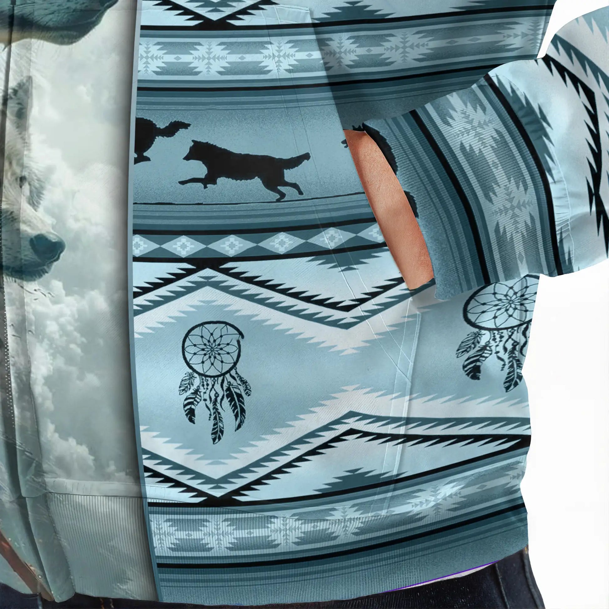 Close-up of blue tribal stripes with silhouetted wolves and dreamcatcher motifs on fabric texture