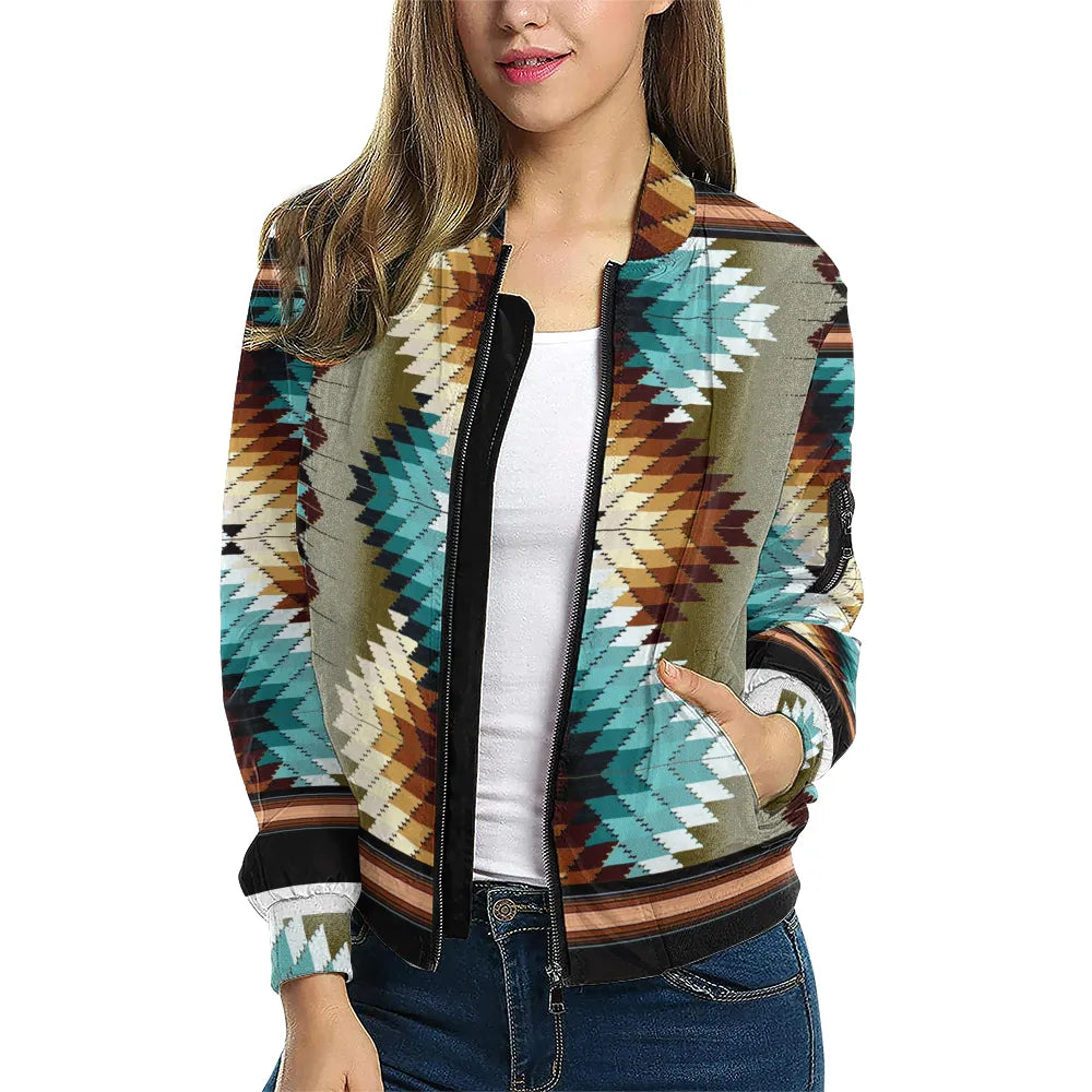 A female model styled in the Tribal Spirit Bomber Jacket, featuring a vibrant arrangement of turquoise and sandstone-colored chevrons, paired with a casual white top and jeans for a bold heritage-meets-modern look.