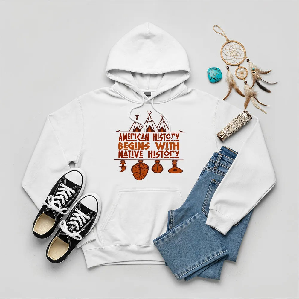 White hoodie featuring brown teepee and feather totem graphic with quote “American History Begins with Native History.