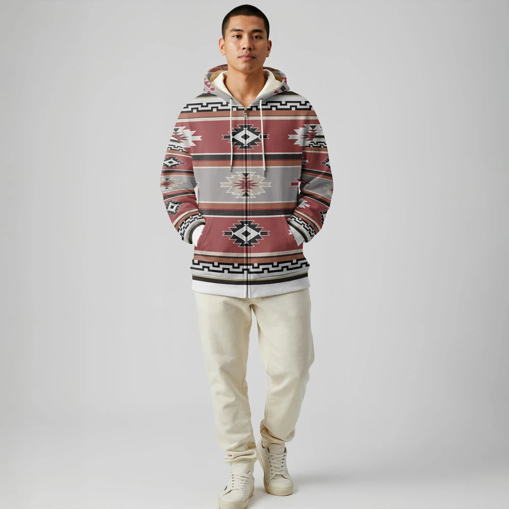 Front view of a male model wearing a rust and ivory geometric Native-American–inspired zip-up hoodie with elastic hem, styled with black pants in a studio environment