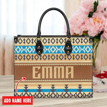 Personalized tribal pattern tote bag with the name “Emma” printed in the center, featuring geometric Native American-inspired designs in blue, tan, and black tones.