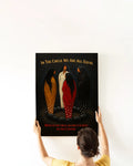Lifestyle shot of a woman hanging the “In The Circle We Are All Equal” canvas print.