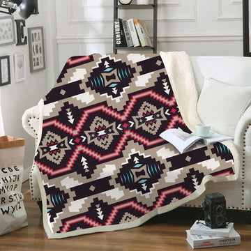 Great Basin Native American tribal geometric pattern sherpa blanket draped over a white sofa with bold colors and traditional design