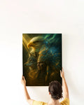 Hands hanging a framed Native America canvas print on a white wall, featuring an eagle, a wolf, and a tribal chief with a star‑speckled feather headdress.
